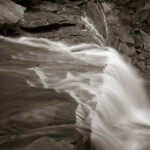 Sitting, pondering, listening, cooling off. Above a waterfall in the Allegheny Mountains.<br /><br /> B&W fine art image of Elekala Falls WV