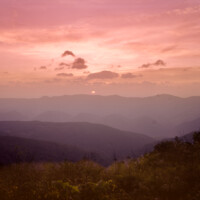 Mysterious shadows give way to a radiant, rose sky during this moment on Spruce Knob in the Appalachian Mountains in West Virginia.<br /><br /> Color vista from the Allegheny Front at sunrise
